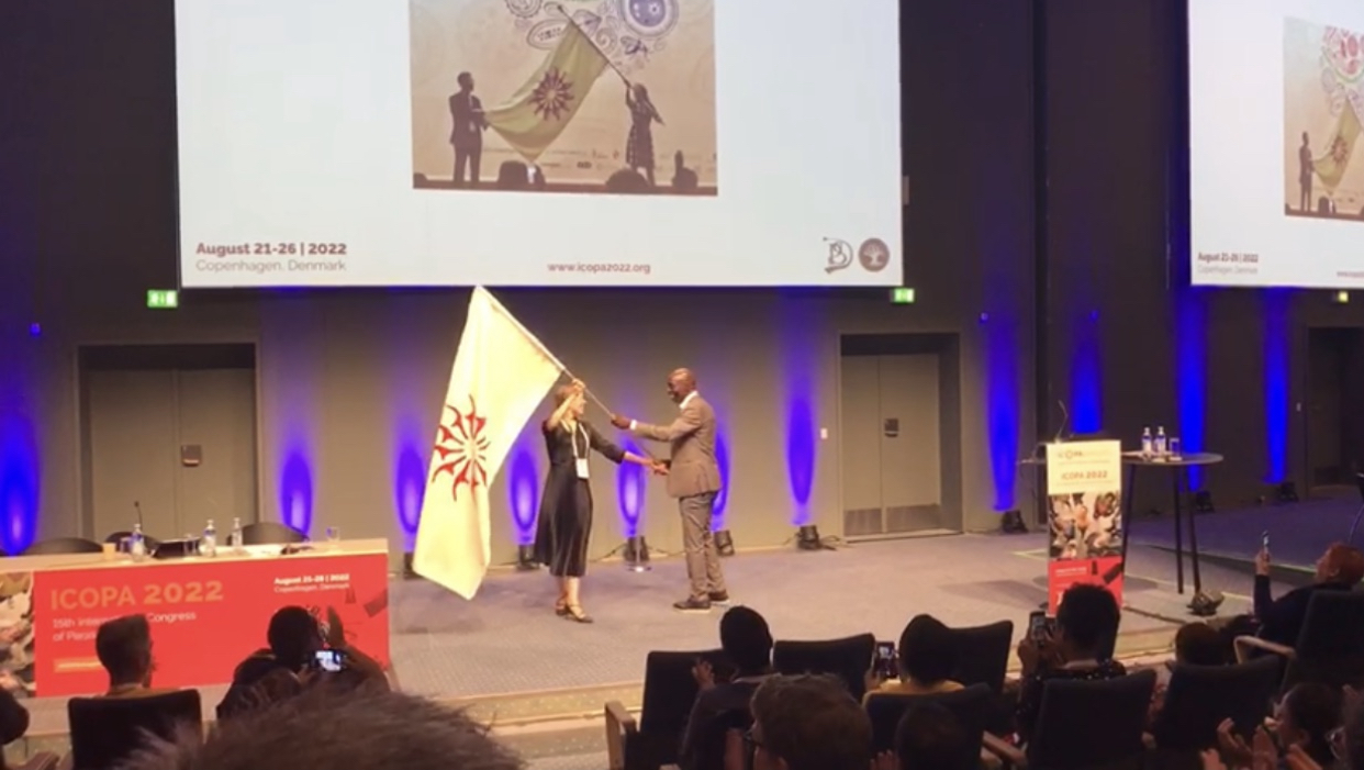 Momar Ndao receives the ICOPA flag.